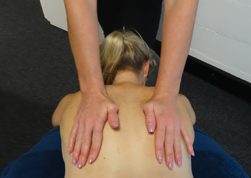Massage therapist Hollie Morse giving hands on treatment at No More Niggles massage therapy clinic, Robina, Gold Coast